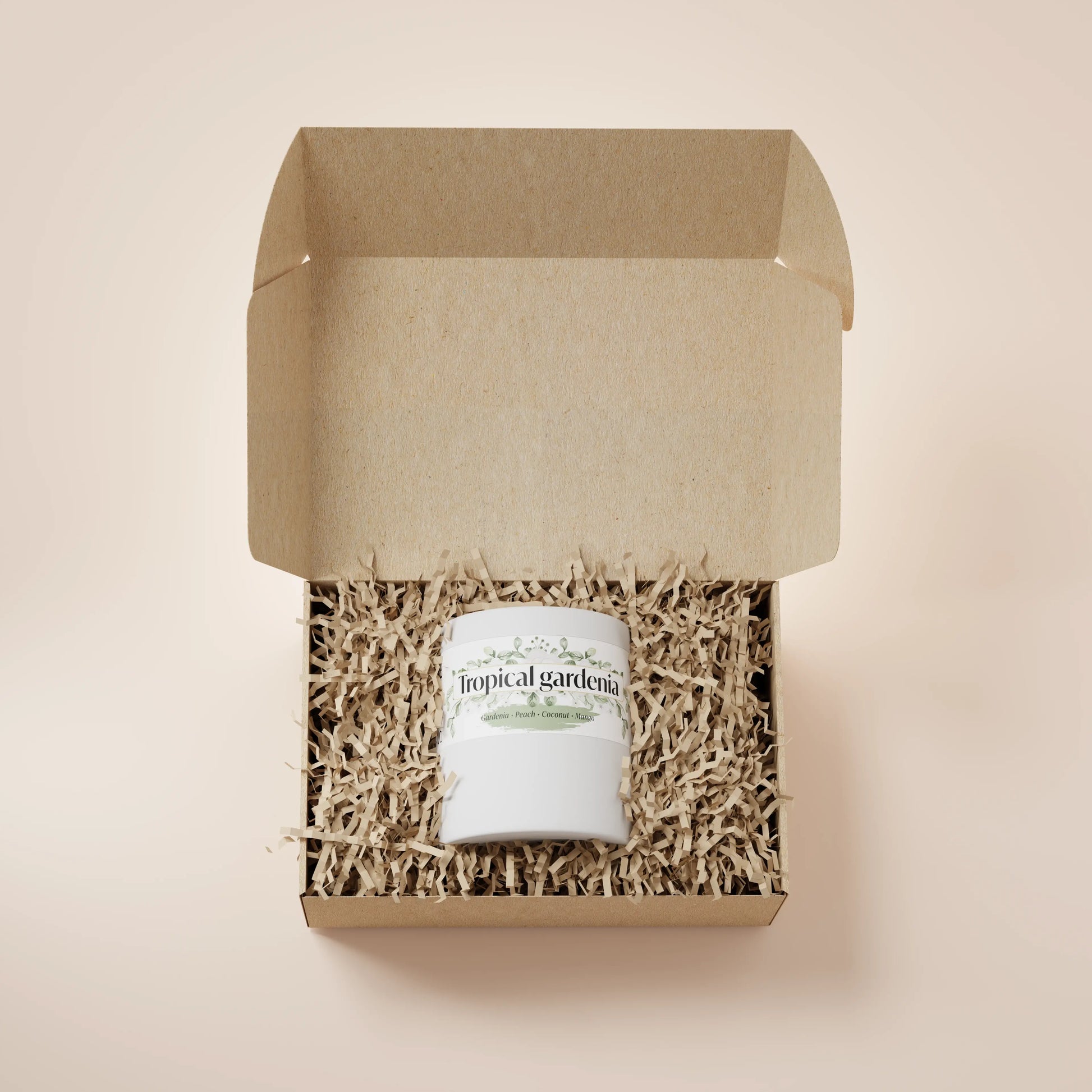 White Ceramic 12oz Tropical Gardenia Scented Candle in a box with crinkle paper.